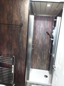 a shower with a glass door in a bathroom at IVY- Braveheart Guest House in Edinburgh