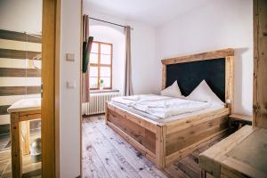 a bedroom with a wooden bed and a window at Schloss Hotel Wurzen in Wurzen