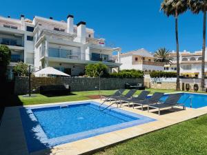 a swimming pool in front of a large building at Javea Ocean View II in Jávea