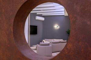 a living room with a couch and a mirror at Hotel Continental in Caorle