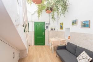 a living room with a green door and a table at Agaete Botanic - Rooftop Solarium in Agaete
