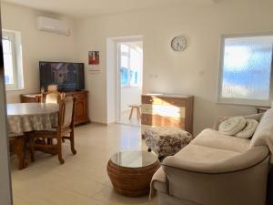 a living room with a couch and a table at Neve in Kali +27 photos