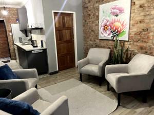 a waiting room with chairs and a painting on the wall at The Chameleon in Centurion