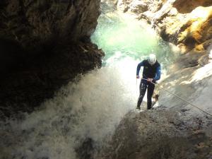 a man standing in a cave with a rope at Adventure Panorama "Salober" Top 9 in Warth am Arlberg