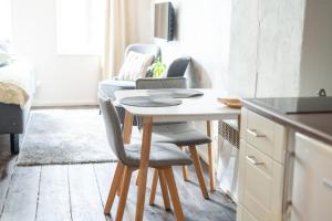 a kitchen with a table and chairs in a room at Garden Studio next to Telliskivi & Old Town in Tallinn