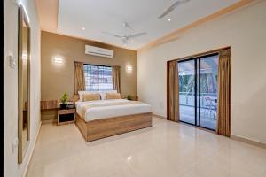 a bedroom with a bed and a large window at Kohinoor Exotica in Lonavala +50 photos