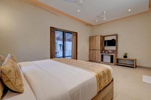 a bedroom with a large bed and a large window at Kohinoor Exotica in Lonavala