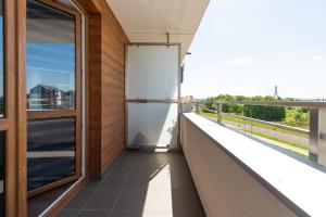 an open door on the balcony of a building at 3 Bedrooms Premium Bella Blue for 8 Guests with AC and Free out side Parking in Rzeszów