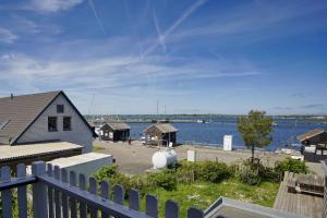 a view of a harbor with a house and the water at Haus ButjeButje Haus - Terrasse, Sauna, Yachthafen in Gager