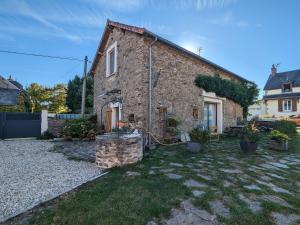 a stone house with a garden in front of it at Suite familiale paisible avec activités en plein air et confort moderne - FR-1-591-447 in Vijon