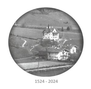 an old black and white photo of a house at Pension Rainhof in Kitzbühel