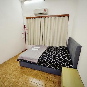 a small room with a bed with a window at Cheras Landed Homestay 4BR - 10Pax - MRT Suntex in Cheras
