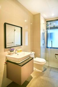 a bathroom with a sink and a toilet and a mirror at Continew Residence KL CoBNB in Kuala Lumpur