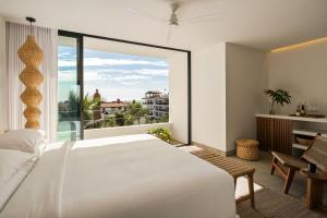 a bedroom with a large white bed and a large window at The Tryst Puerto Vallarta LGBT Hotel in Puerto Vallarta