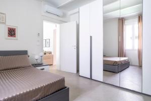 een slaapkamer met een bed en een spiegel bij MONO Apartments Aldini in Bologna