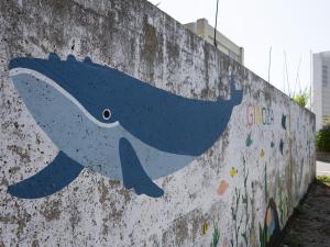 a painting of a whale painted on a wall at くぶむ荘 in Shimoyatori