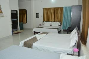 a hotel room with two beds in a room at Hotel Chandrasha Villa in Ayodhya