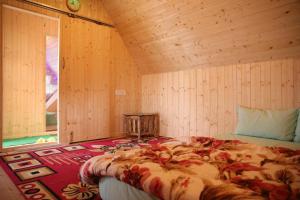 a bedroom with a bed in a wooden room at Cozy Nest Homestay in Kurseong