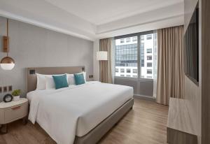 Lanson Place Mall of Asia Manila客房内的一张或多张床位