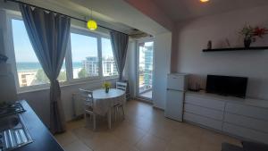 a kitchen with a table and a kitchen with a window at Mamaia Summerland Seaview in Mamaia