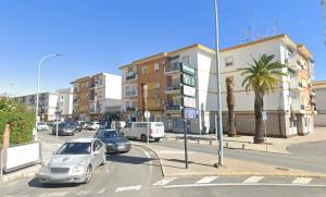 a street with cars driving down a street with buildings at Océano Home in Ayamonte