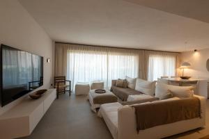 a living room with a couch and a tv at OVILIO KALAMATA in Kalamata