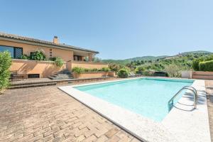 una piscina di fronte a una casa di Villa Chiara Relax a Giano dellʼUmbria