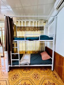 a bedroom with two bunk beds in a room at Hà Giang Tiamo Adventure in Ha Giang