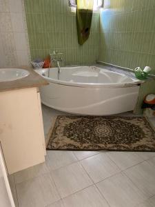 a bath tub and a sink in a bathroom at Dar kouka in Tataouine