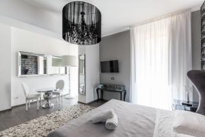 a bedroom with a bed and a chandelier at Town House Roma in Rome