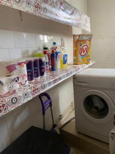 a laundry room with a washing machine on a shelf at Dar kouka in Tataouine