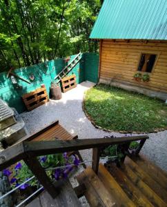 a backyard with a bench and a wooden cabin at Brvnara Fairy Tale in Cetinje