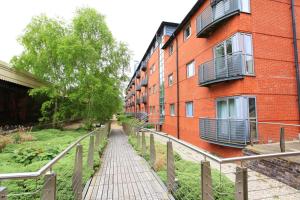 a walkway in front of a red brick building at Broad Gauge Apartments in Wolverhampton