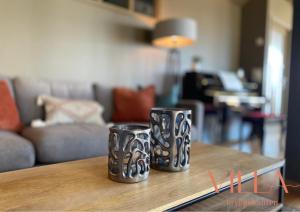 two black and white vases sitting on a table at Villa Bryggekanten - by Classic Norway Hotels in Henningsvær