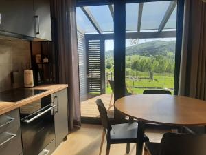 a kitchen with a table and a view of a mountain at Love Wysove in Wysowa-Zdrój