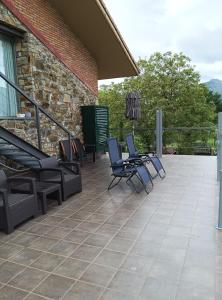 a patio with chairs and tables and a building at Estudio y Loft Durango in Guyuria