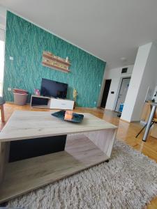 salon ze stołem i kanapą w obiekcie Krstić_lux apartman w mieście Subotica