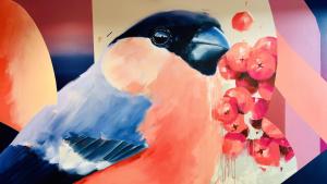 a painting of a colorful parrot with berries at City Résidence Bordeaux Centre in Bordeaux