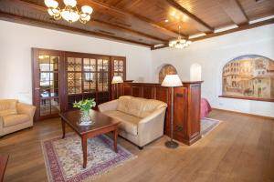 a living room with a couch and a table at Daugirdas Old City Hotel in Kaunas