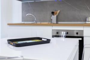 a kitchen counter with a black tray on the counter at Zen Orlando house in Taormina