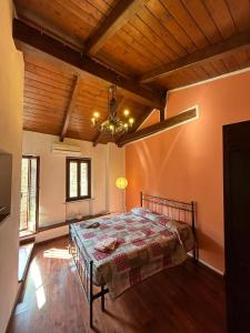 a bedroom with a bed and a wooden ceiling at Al Vicolo Uno in Montemagno +42 photos