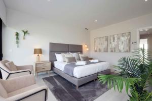 a bedroom with a bed and a desk and a chair at Modern Townhouse on San Roque Golf Club in San Roque +29 photos