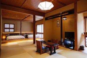 Voodi või voodid majutusasutuse Arifuku Onsen Yoshidaya toas