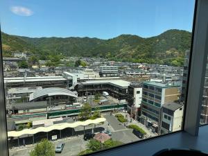 a view of a city from a window at Kyoto Yamashina Hotel Sanraku in Kyoto