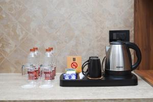 a coffee maker sitting on top of a counter at Classic Regency in Alleppey