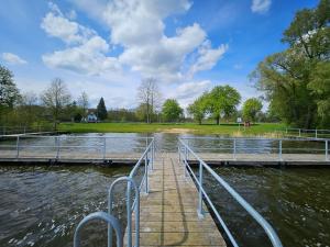 a dock on a body of water at Ferienwohnung 2 Am Rodelberg in Priborn +10 photos