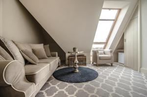 a living room with a couch and a chair at Willa Legenda Hotel Adults Only in Mielno