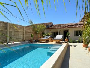 a swimming pool in the backyard of a house at Emina Palms in Nea Vrasna