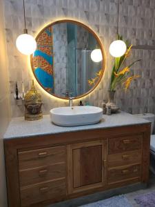 a bathroom with a sink and a mirror at Studio guesthouse 38 in Lovina in Lovina