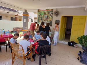 a group of people sitting around a table in a room at Greenleaf Angsana Homestay in Jerantut